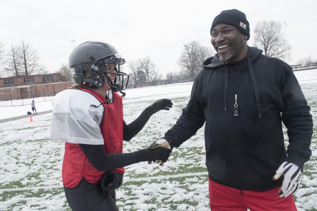 Renegades quarterback Allison Cahill laughs with head coach Donnie Williams after their scrimmage against the Independent Women’s Football League’s Washington Prodigy in Philadelphia, March 21, 2015. (Wicked Local Staff Photo/ Sam Goresh) 
