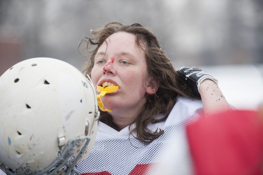 Renegades defensive tackle Michelle Breden adjusts her helmet between plays in their scrimmage against the Independent Women’s Football League’s Washington Prodigy in Philadelphia, March 21, 2015. The team drove to Philadelphia to give a newer players a chance to play against other teams, but also to play against teams that no longer wanted to play with the Militia. (Wicked Local Staff Photo/ Sam Goresh)