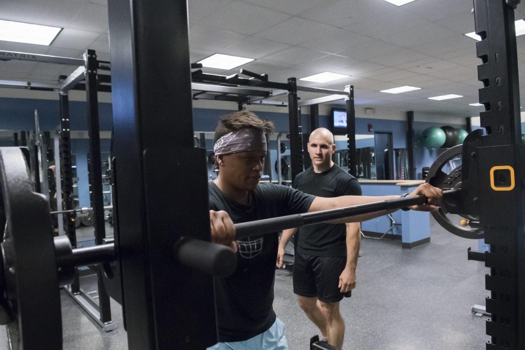 Renegades general manager Ben Brown trains with chief operating officer and player Mia Brickhouse at Cambridge Athletic Club, June 4, 2015. Brown, an NSCA Certified Strength and Conditioning Specialist and USA Track and Field and USA Weightlifting Coach works with some of the Renegades players off the field as well as leading the warmup exercises for the team before practices and games. (Wicked Local Staff Photo/ Sam Goresh)