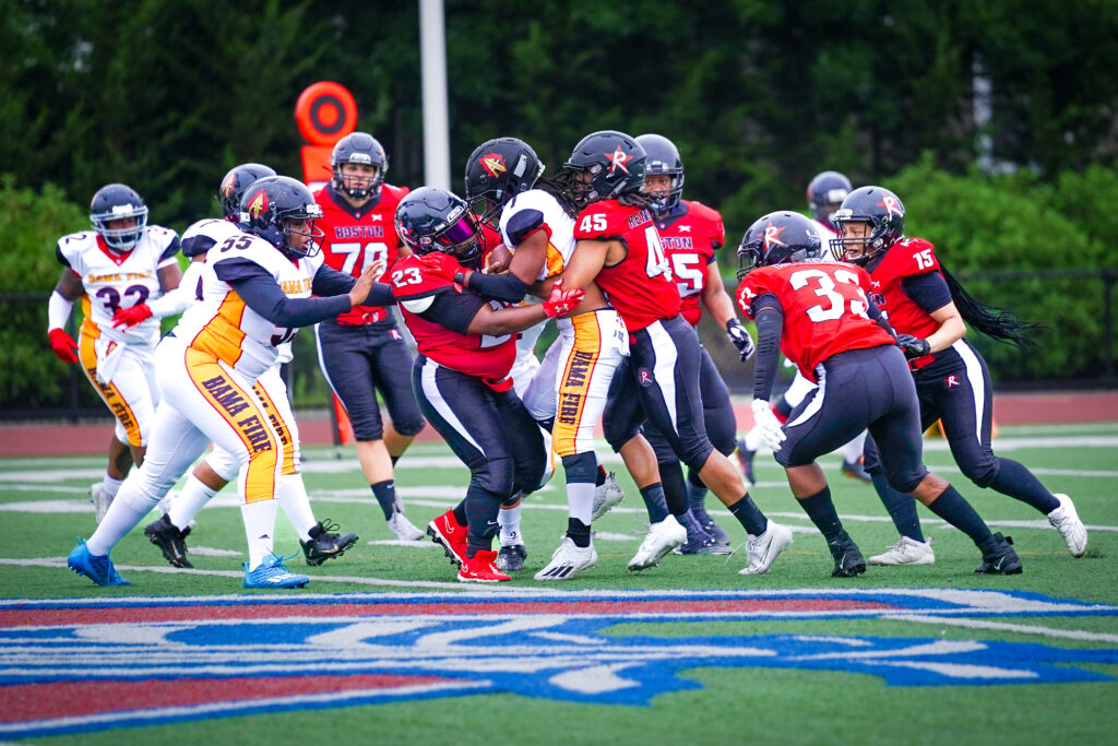 Spring Gamble and Darcy Leslie of the Boston Renegades tackle Kelli Smith of the Alabama Fire.