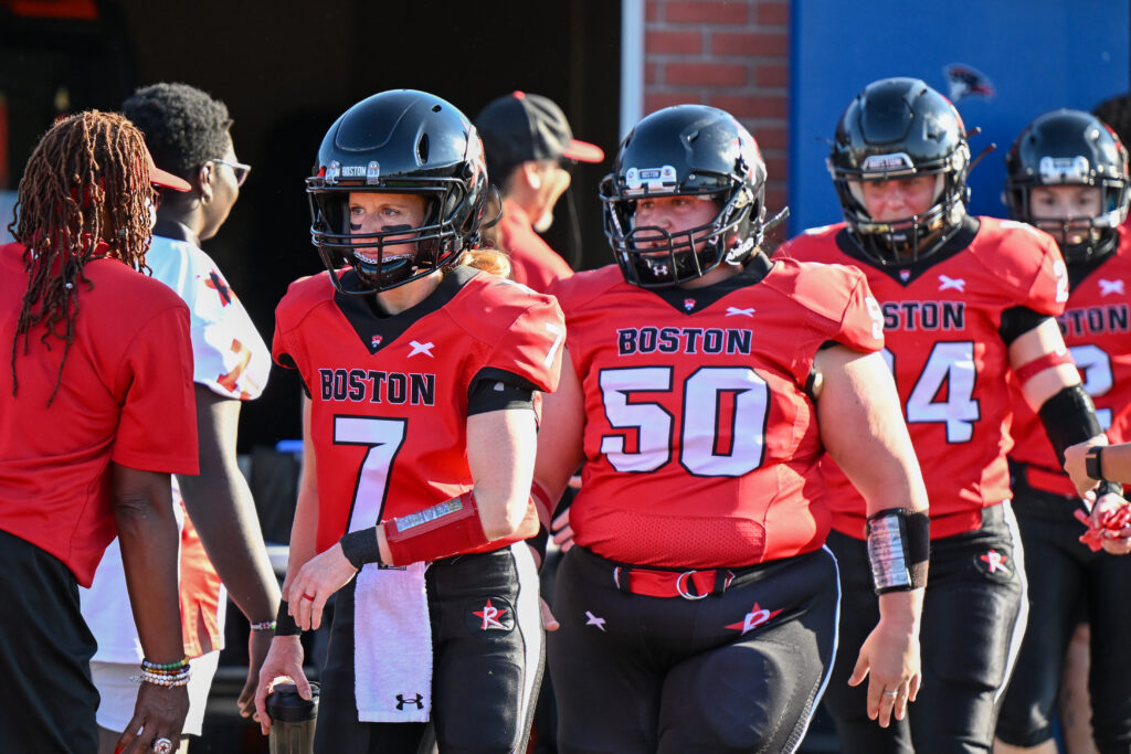 Amanda Alpert and Allison Cahill walk toward the football field